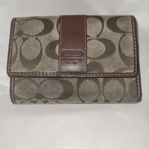 Authentication coach trifold wallet